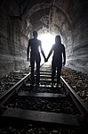 Couple Walking Together Through A Railway Tunnel Stock Photo