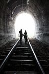 Couple Walking Together Through A Railway Tunnel Stock Photo