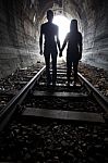 Couple Walking Together Through A Railway Tunnel Stock Photo