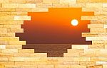 Crashed Brick Wall With Beautiful Sun Set Over The Sea Behind Stock Photo