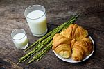 Croissant On Dish With Rice Milk And Ear Of Rice  On Old Wooden Stock Photo