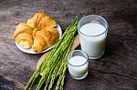 Croissant On Dish With Rice Milk And Ear Of Rice  On Old Wooden Stock Photo