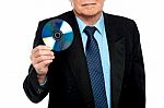 Cropped Image Of A Male Showing Compact Disk Stock Photo