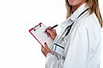 Cropped Image Of Doctor Writing On Clipboard Stock Photo