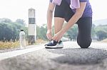 Cropped Shot Of Young Women Runner Tightening Running Shoe Laces Stock Photo