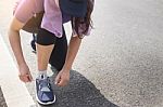 Cropped Shot Of Young Women Runner Tightening Running Shoe Laces Stock Photo