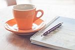 Cup Of Coffee With Pen And Spiral Notebook Stock Photo