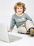 Curl Hair Boy Near Laptop Stock Photo