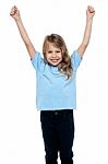 Cute Caucasian Girl Celebrating With Raised Arms Stock Photo