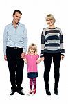 Cute Daughter Holding Hands Of Her Parents Tightly Stock Photo