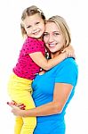 Cute Daughter Hugging Her Mom. Casual Shot Stock Photo