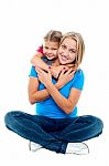 Cute Daughter Hugging Her Mother From Behind Stock Photo