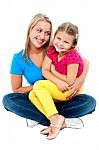 Cute Daughter Sitting In Mother's Lap Stock Photo