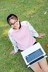 Cute Girl Is Happy With Notebook On Grass Stock Photo