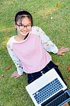 Cute Girl Is Happy With Notebook On Grass Stock Photo