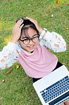 Cute Girl Is Happy With Notebook On Grass Stock Photo