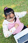 Cute Girl Is Happy With Notebook On Grass Stock Photo