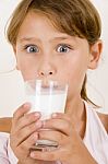 Cute Little Girl Drinking Milk Stock Photo