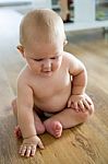 Cute Smiling Baby Sitting At Home Stock Photo