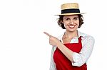 Cute Woman In Hat Pointing Sideways Stock Photo