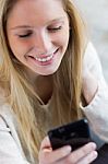 Cute Young Woman Chatting With Their Smartphone Stock Photo