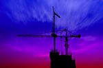 Dark Twilight And Silhouette Construction With Crane On Top Building Stock Photo