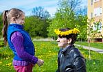 Daughter Puts On Her Mom's Head A Wreath Of Dandelions Stock Photo