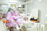 Dentist And Dental Assistants In Hospital ( Blurry Dental Background ) In Thailand Stock Photo