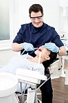 Dentist Examine On A Female Patient Stock Photo