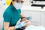 Dentist Examining Mouth Of Patient Stock Photo