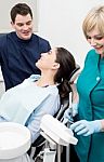 Dentist Explaining Teeth Model To Patient Stock Photo