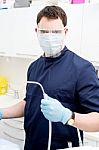 Dentist Holding Dental Tools Stock Photo