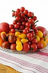 Different Varieties Of Tomatoes In A Glass Vase Stock Photo