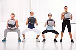 Diverse Group Of People Exercising With Pilates In Gym Stock Photo