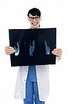 Doctor Displaying X-ray Report Of Thumb Finger Stock Photo