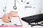 Doctor Writing On Clipboard Stock Photo