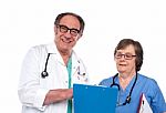 Doctors Reading Medical Report Stock Photo