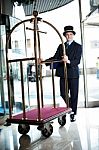 Doorman Pushing A Cart Stock Photo