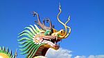 Dragon Statue Under Blue Dragon Sky Stock Photo