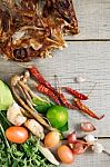 Dried Fish And Spices On Wooden Stock Photo