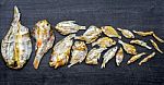 Dry Fish With Sunny On Black Wooden Floor Stock Photo