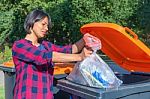 Dutch Woman Throwing Plastic Garbage In Thrash Bin Stock Photo