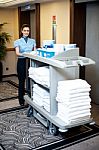 Employee Pushing Housekeeping Cart Stock Photo