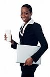 Employer Holding Laptop And Beverage Stock Photo