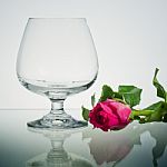 Empty Brandy Glass And Rose Stock Photo