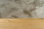 Empty Wooden Board In Front Of Blur Concrete Stock Photo