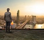 Engineering Man Standing On Top Of Building Looking To Urban Sce Stock Photo