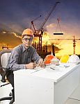 Engineering Man With Safety Helmet Working Table Against Buildin Stock Photo