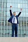 Excited Businessman Raising His Arms Stock Photo