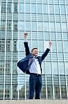 Excited Businessman Raising His Arms Stock Photo